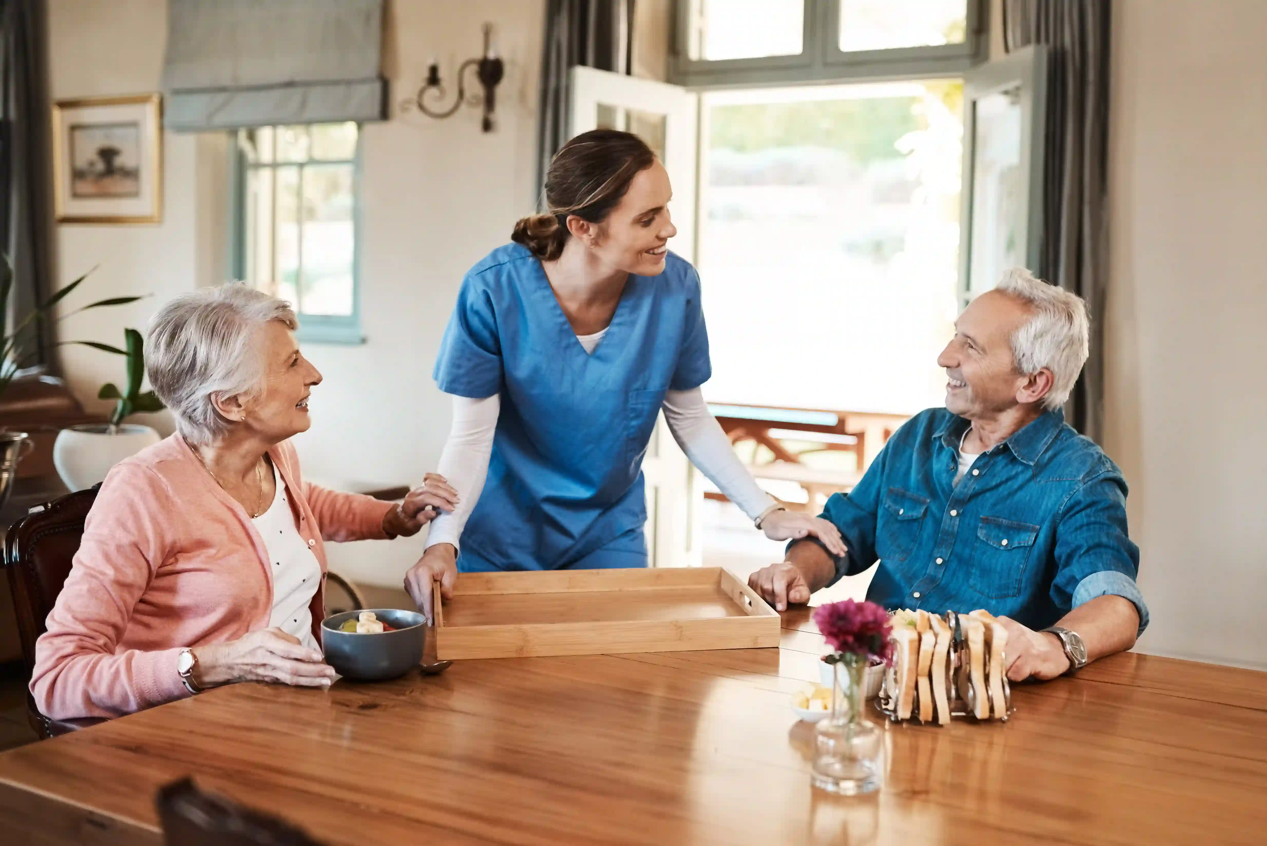 Nurse caring for elderly couple in a group home